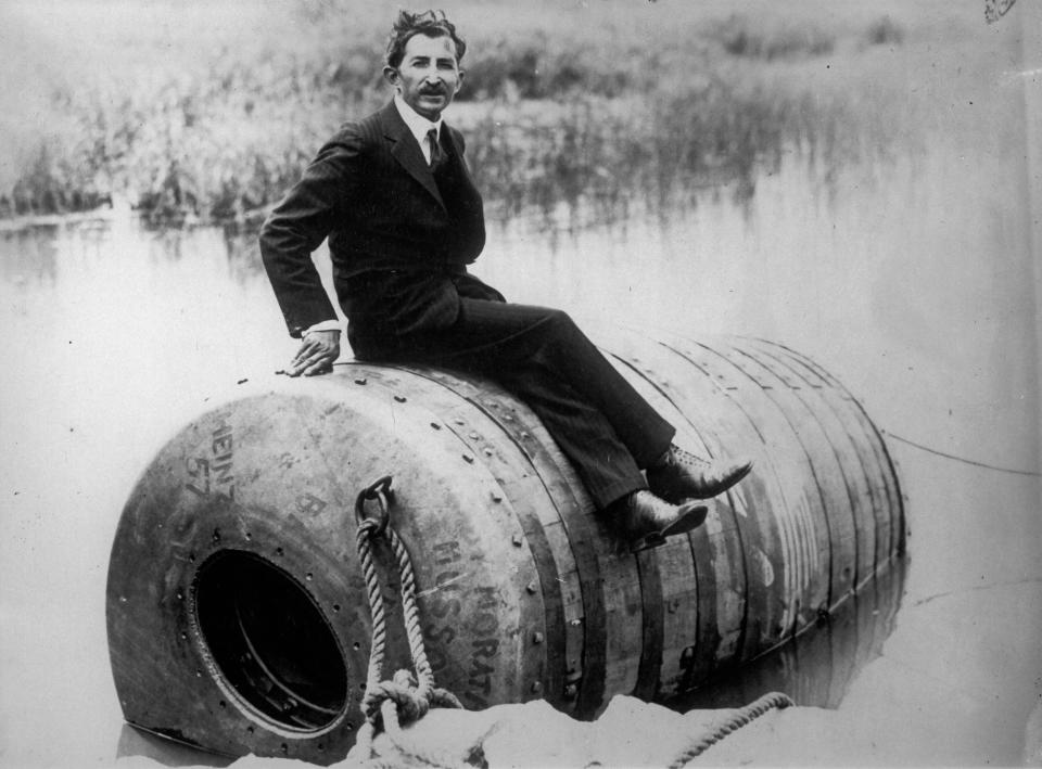 George Stathakis sitting on top of the barrel he rode down Niagara Falls.