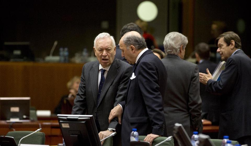 French Foreign Minister Laurent Fabius, center right, puts his hand on the arm of Spanish Foreign Minister Jose Manuel Garcia-Margallo while speaking during an emergency meeting of EU foreign ministers at the EU Council building in Brussels on Monday, March 3, 2014. EU foreign ministers meet in emergency session on Monday to discuss the ongoing crisis in Ukraine. (AP Photo/Virginia Mayo)