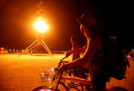 <p>Participants watch the flames on the Spire of Fire as approximately 70,000 people from all over the world gather for the 30th annual Burning Man arts and music festival in the Black Rock Desert of Nevada, Aug. 29, 2016. (REUTERS/Jim Urquhart)</p>