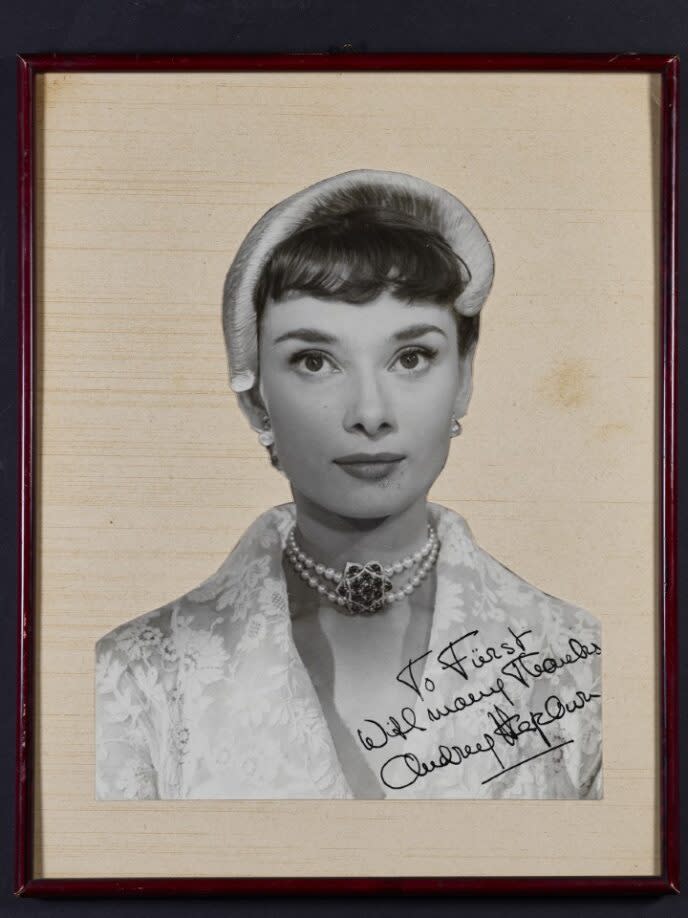 An autographed picture of Hepburn wearing the necklace.