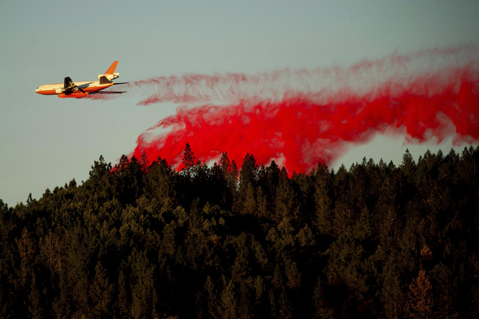 An air tanker drops retardant while battling the Kincade Fire near Healdsburg, Calif., on Tuesday, Oct. 29, 2019. The overall weather picture in northern areas is improving as powerful, dry winds bring extreme fire weather to Southern California. (AP Photo/Noah Berger)
