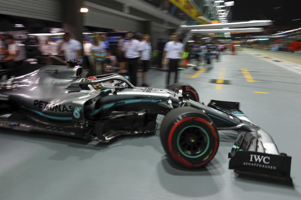 Mercedes driver Lewis Hamilton of Britain pulls out of his garage during the second practice session at the Marina Bay City Circuit ahead of the Singapore Formula One Grand Prix in Singapore, Friday, Sept. 20, 2019. (AP Photo/Vincent Thian)