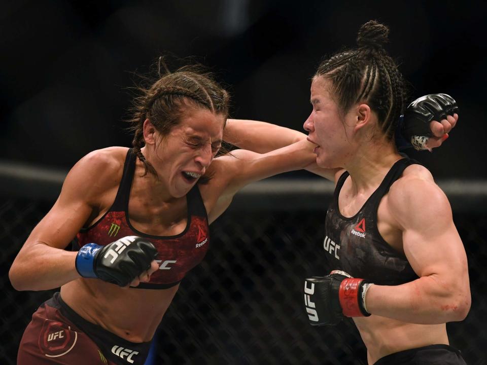 Zhang Weili (right) and Joanna Jedrzejczyk trade shots in their first fight (Getty)