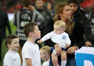 Rooney’s wife, Coleen , and children on the pitch before kick-off (Nick Potts/PA)