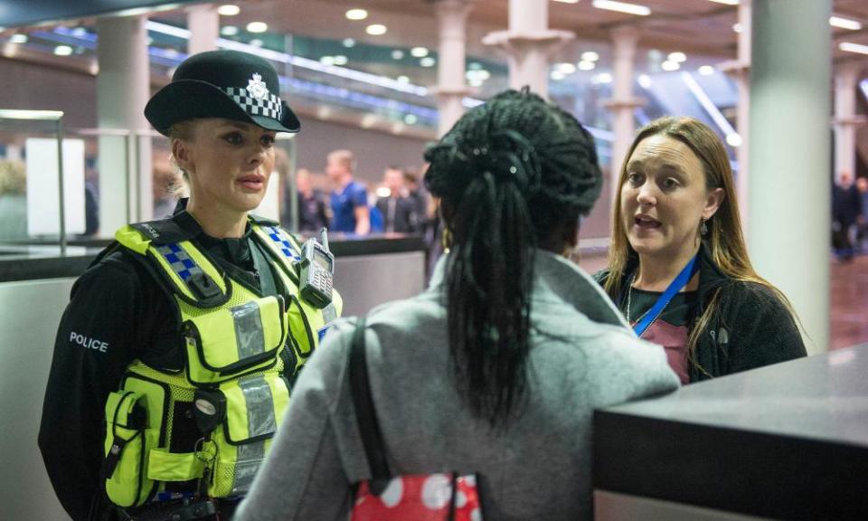 A British Transport Police officer and Metropolitan police constable talk to a woman arriving on the Eurostar from Brussels.