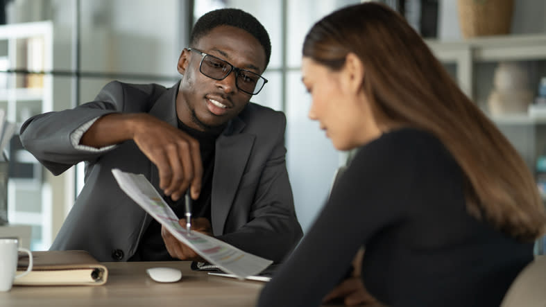 A financial advisor guiding a client on her investment plan.