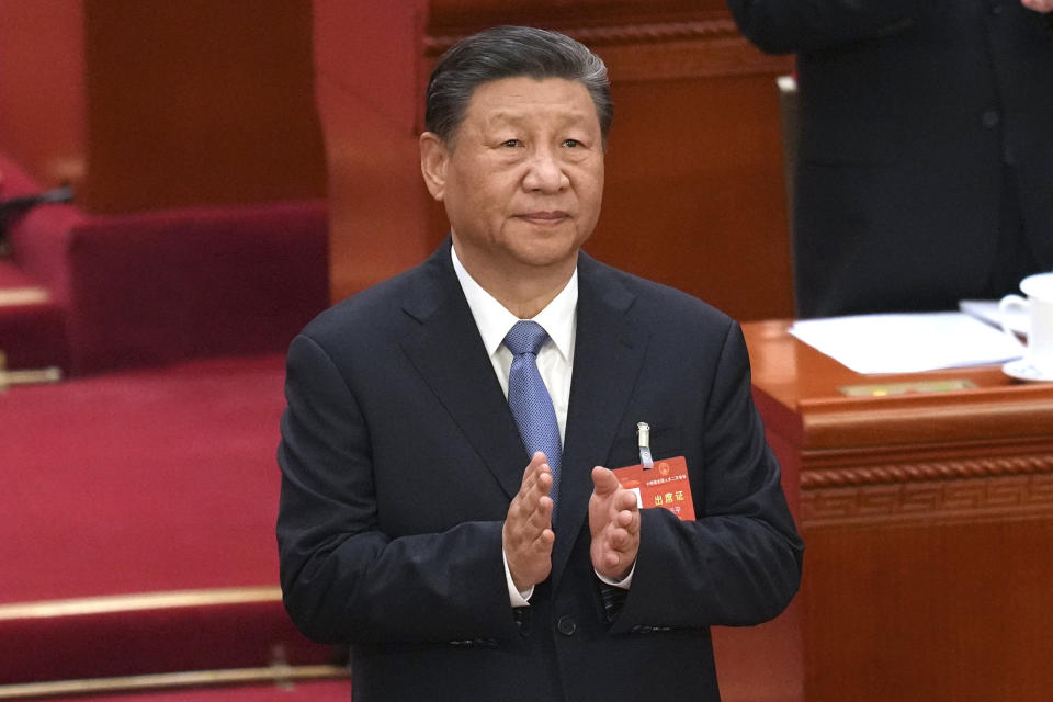 Chinese President Xi Jinping applauds during the second plenary session meeting of the National People's Congress (NPC) in the Great Hall of the People in Beijing, Friday, March 8, 2024. (AP Photo/Tatan Syuflana).