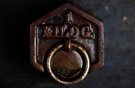 A one kilogram weight is seen in Saussay-la-Campagne, western France, November 15, 2018. REUTERS/Christian Hartmann