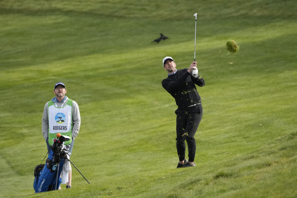 Aaron Rodgers follows his approach shot up to the second green of the Spyglass Hill Golf Course during the first round of the AT&T Pebble Beach Pro-Am golf tournament in Pebble Beach, Calif., Thursday, Feb. 2, 2023. (AP Photo/Eric Risberg)