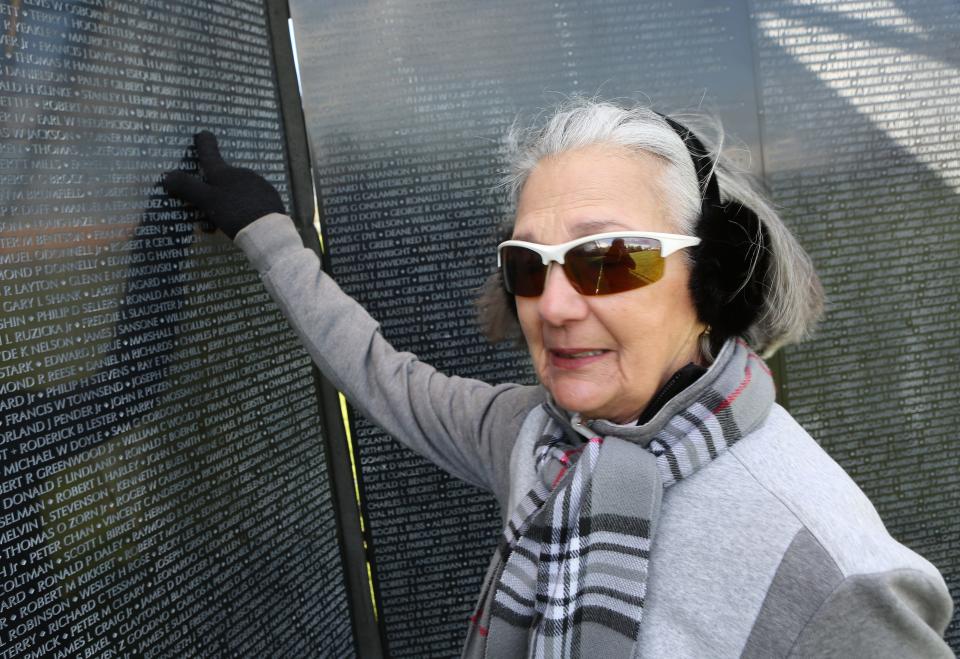 Therea Orecchia, of Wilmington, points to the name of her husband Edwin G. Northup on The Wall That Heals Thursday morning near New Castle.  Therea said Edwin was killed in 1972 in a helicopter crash during a rescue mission in Vietnam.