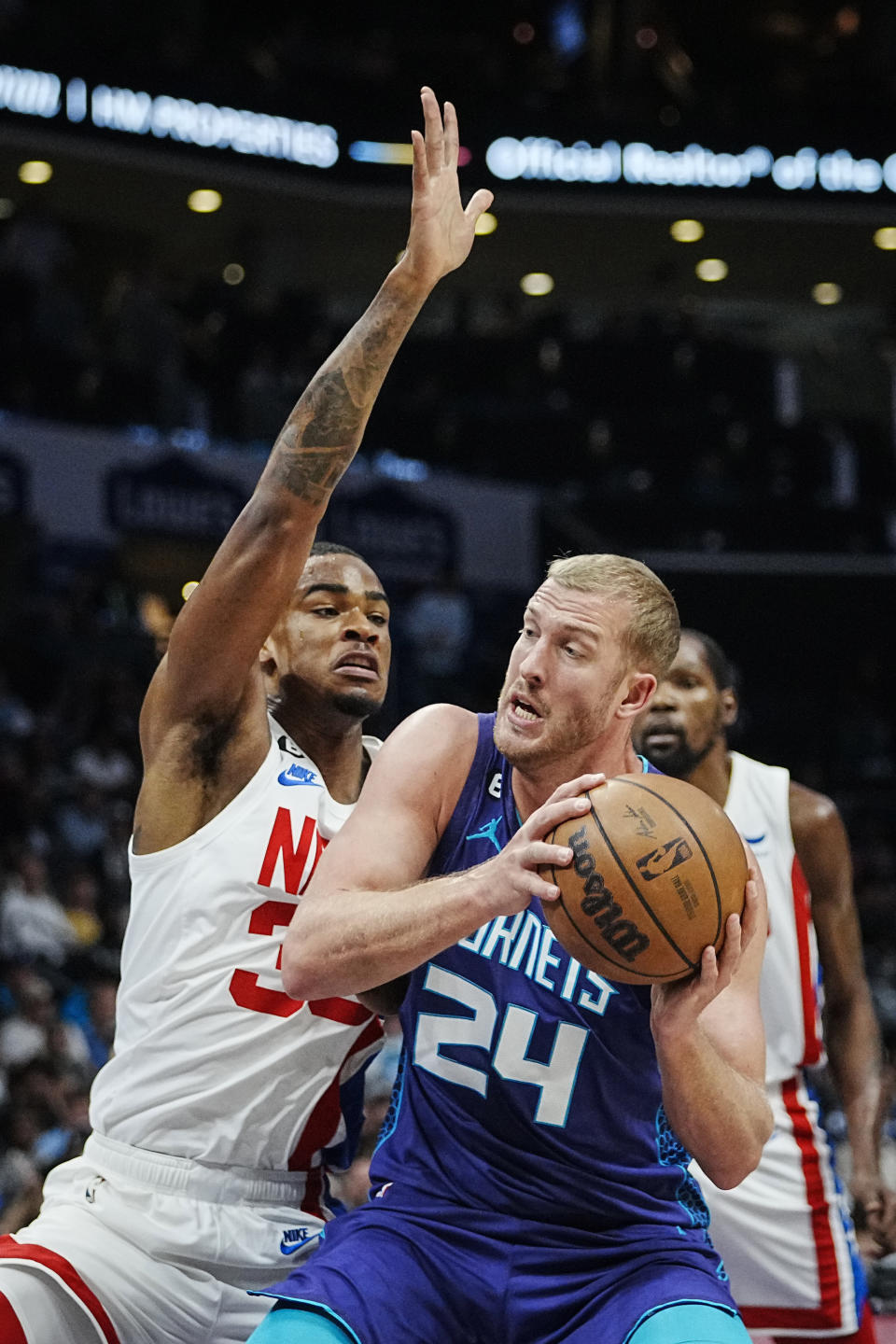 Charlotte Hornets center Mason Plumlee (24) works into the lane against Brooklyn Nets forward Nic Claxton, left, during the first half of an NBA basketball game, Saturday, Nov. 5, 2022, in Charlotte, N.C. (AP Photo/Rusty Jones)