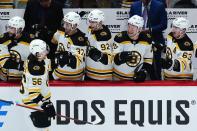 Boston Bruins left wing Erik Haula (56) celebrates his goal against the Arizona Coyotes with Bruins' Craig Smith (12), Patrice Bergeron (37), Tomas Nosek (92) Curtis Lazar (20) and Brad Marchand (63) during the first period of an NHL hockey game Friday, Jan. 28, 2022, in Glendale, Ariz. (AP Photo/Ross D. Franklin)