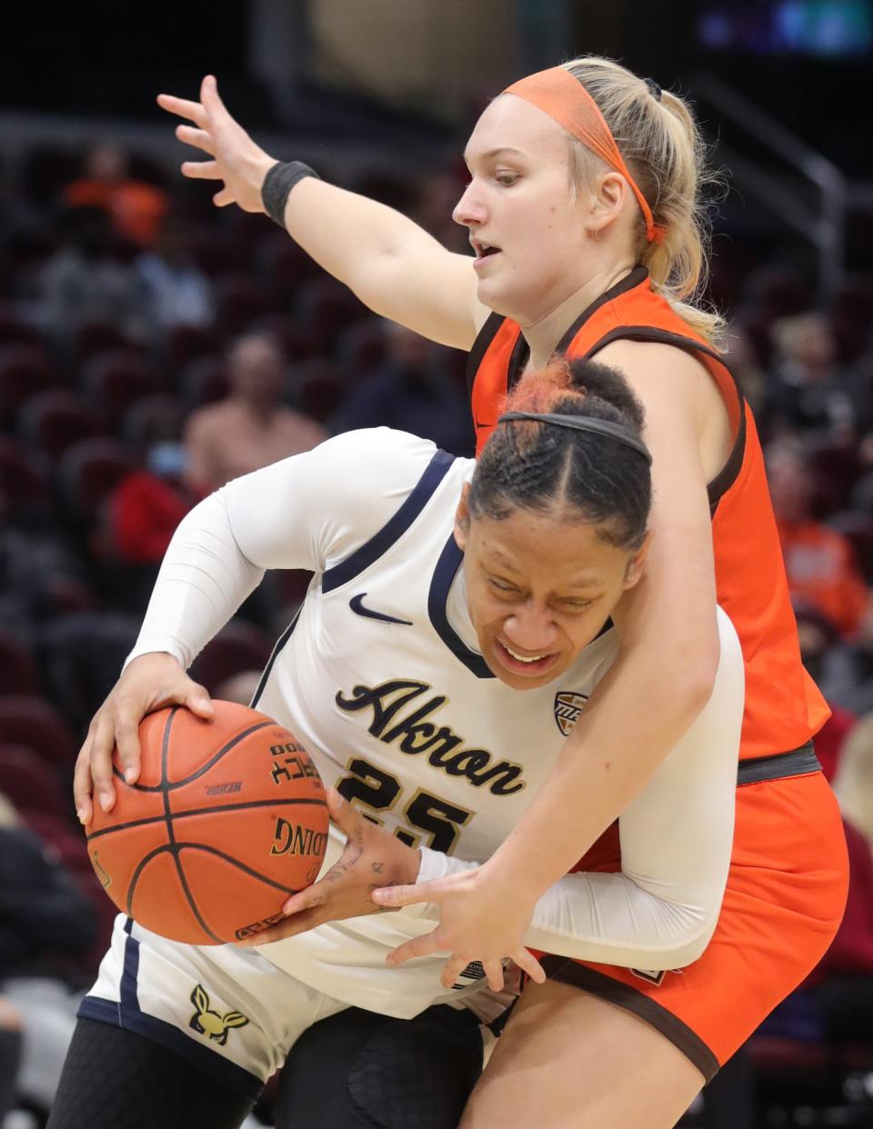 Akron's Jordyn Dawson is fouled by Bowling Green's Elissa Brett as she drive to the basket in a Mid American Conference Tournament quarterfinal game on Wednesday March 9, 2022 in Cleveland, Ohio, at Rocket Mortgage FieldHouse.