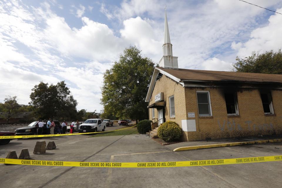 Area residents and church members observe as authorities investigate the fire damaged Hopewell M.B. Baptist Church in Greenville, Miss., Wednesday, Nov. 2, 2016. (Photo: Rogelio V. Solis/AP)