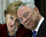 FILE - In this Jan. 12, 2006 file photo, German Chancellor Angela Merkel, left, smiles next to former Secretary of State Colin Powell, during a reception at the German Embassy in Washington. Powell, former Joint Chiefs chairman and secretary of state, has died from COVID-19 complications. In an announcement on social media Monday, the family said Powell had been fully vaccinated. He was 84. (AP Photo/Michael Dalder, Pool)