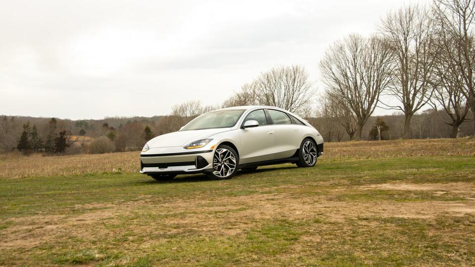 a silver four door sedan parked on the grass