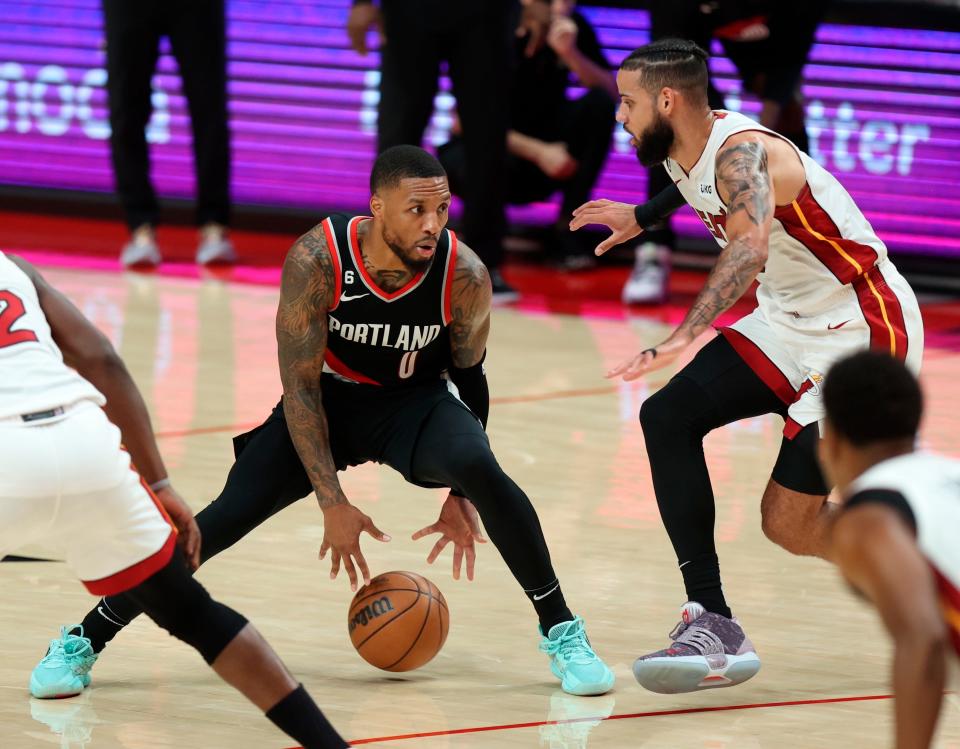 Portland Trail Blazers guard Damian Lillard, left, looks to drive past Miami Heat forward Caleb Martin, right, during the second half of an NBA basketball game in Portland, Ore., Wednesday, Oct. 26, 2022. (AP Photo/Steve Dipaola)