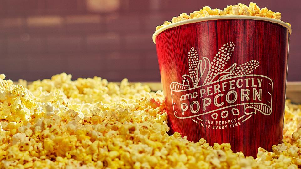 AMC Theatres popcorn tub surrounded by popcorn