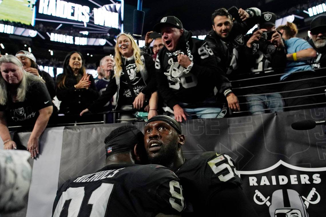 Las Vegas Raiders defensive end Chandler Jones, right, reacts after scoring on an interception during the second half of an NFL game, Sunday, Dec. 18, 2022, in Las Vegas.