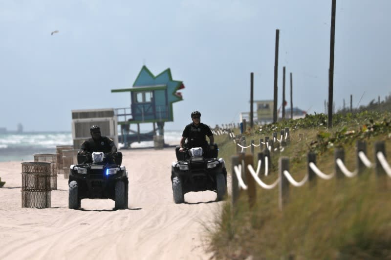 Police officers patrol the beach after local authorities order the closing of all the beaches in Miami-Dade county for precaution due to coronavirus disease (COVID-19) spread, in Miami Beach