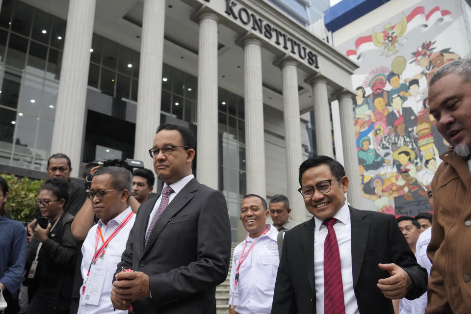 Losing presidential candidate Anies Baswedan, center left, walks with his running mate Muhaimin Iskandar, second right, upon their arrival for hearing appeals against the presidential election results, which were lodged by losing candidates, at the Constitutional Court in Jakarta, Indonesia, Wednesday, March 27, 2024. (AP Photo/Achmad Ibrahim)