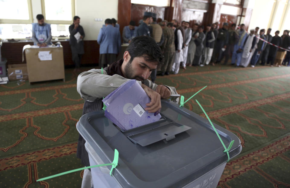 An Afghan man casts his vote in a pooling station during Parliamentary election in Kabul, Afghanistan, Saturday, Oct. 20, 2018. Tens of thousands of Afghan forces fanned out across the country as voting began Saturday in the elections that followed a campaign marred by relentless violence. (AP Photo/Rahmat Gul)