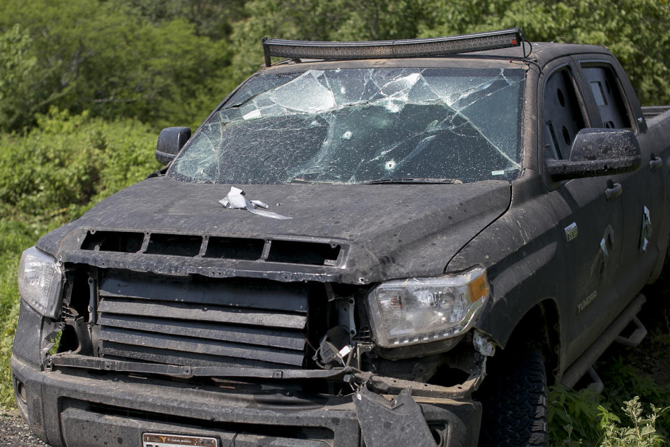 A bullet ridden home-made armored truck lays abandoned on the side of the road, in the outskirts of Tepalcatepec, Michoacan state, Mexico, Saturday, Aug. 31, 2019. Heavily armed bands clashed Friday, for control of Tepalcatepec, leaving at least 9 dead, according the Ministry of Public Security and Citizen Protection. (AP Photo/Armando Solis)