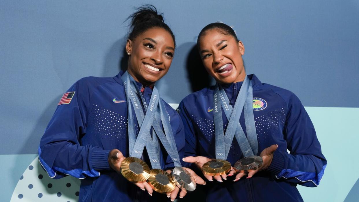 Simone Biles, left, and Jordan Chiles show off the medals they have won during the Paris Olympic Games.