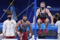 Gymnasts from the United States, from left, Yul Moldauer, Samuel Mikulak, and Shane Wiskus watch teammate Brody Malone performing on the horizontal bar during the artistic men's team final at the 2020 Summer Olympics, Monday, July 26, 2021, in Tokyo. (AP Photo/Ashley Landis)