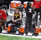 Atlanta Hawks guards Kevin Huerter, left, and Trae Young, who did not play, watch from the bench in the final minute of the team's loss to the Milwaukee Bucks in Game 5 of the Eastern Conference finals in the NBA basketball playoffs Thursday, July 1, 2021, in Milwaukee. (Curtis Compton/Atlanta Journal-Constitution via AP)