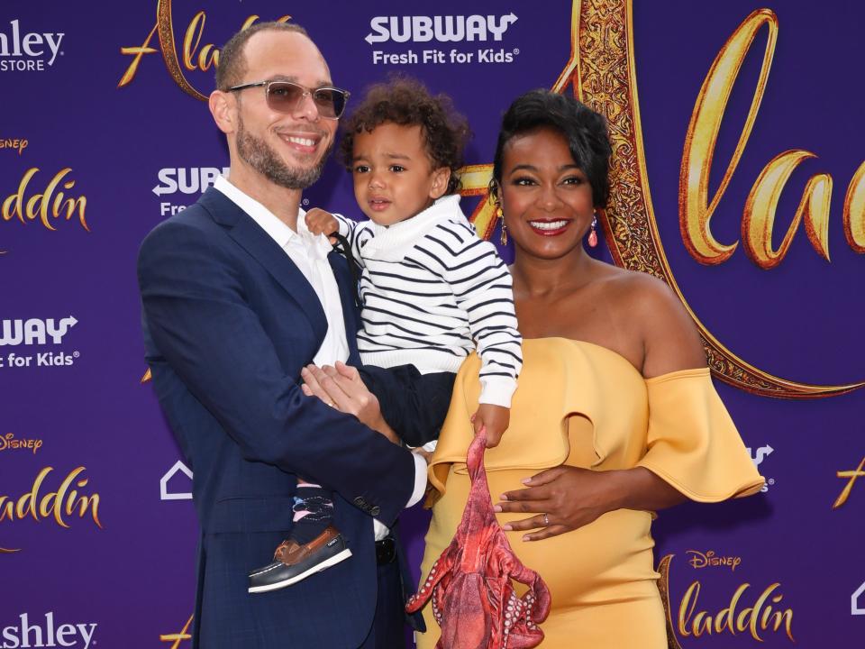 tatyana ali and her husband, vaughn rasberry, and their son, edward at aladdin premiere