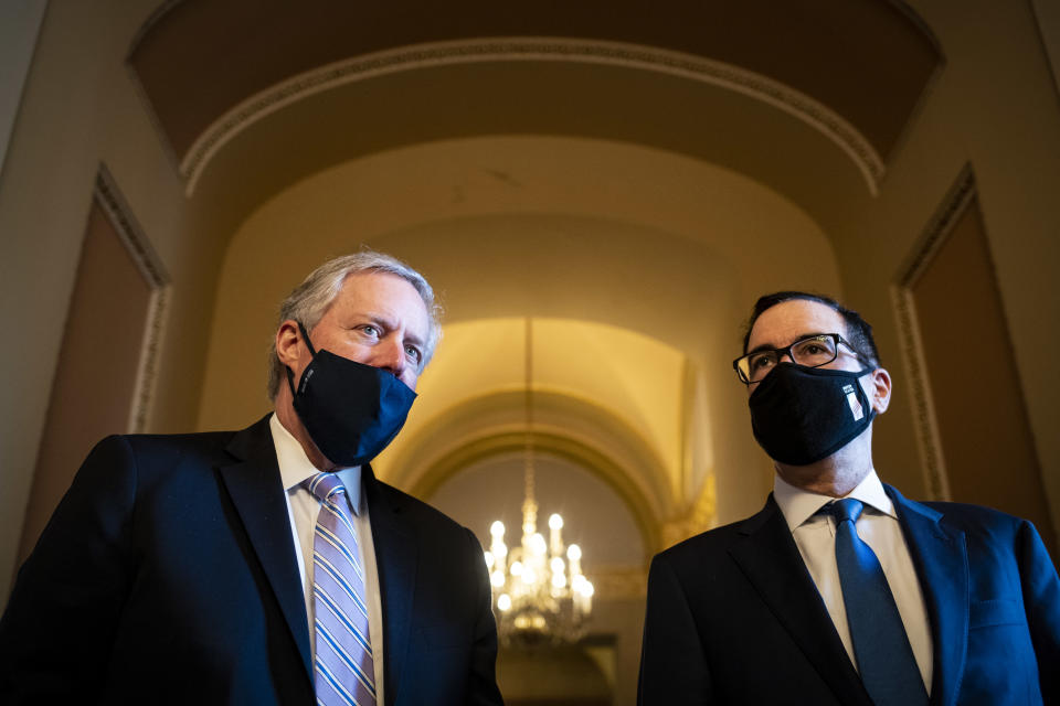 Mark Meadows, White House chief of staff, left, and Steven Mnuchin, U.S. Treasury secretary, wear protective masks while speaking to members of the media after a meeting with Senate Majority Leader Mitch McConnell, a Republican from Kentucky, not pictured, at the U.S. Capitol in Washington, D.C., U.S., on Thursday, July 23, 2020. (Al Drago/Bloomberg via Getty Images)