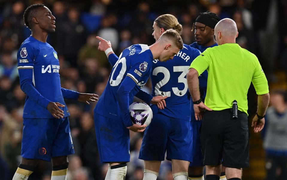 Chelsea's English midfielder #23 Conor Gallagher points at Chelsea's Senegalese striker #15 Nicolas Jackson (L) as Chelsea's English midfielder #20 Cole Palmer (C) prepares to take a penalty during the English Premier League football match