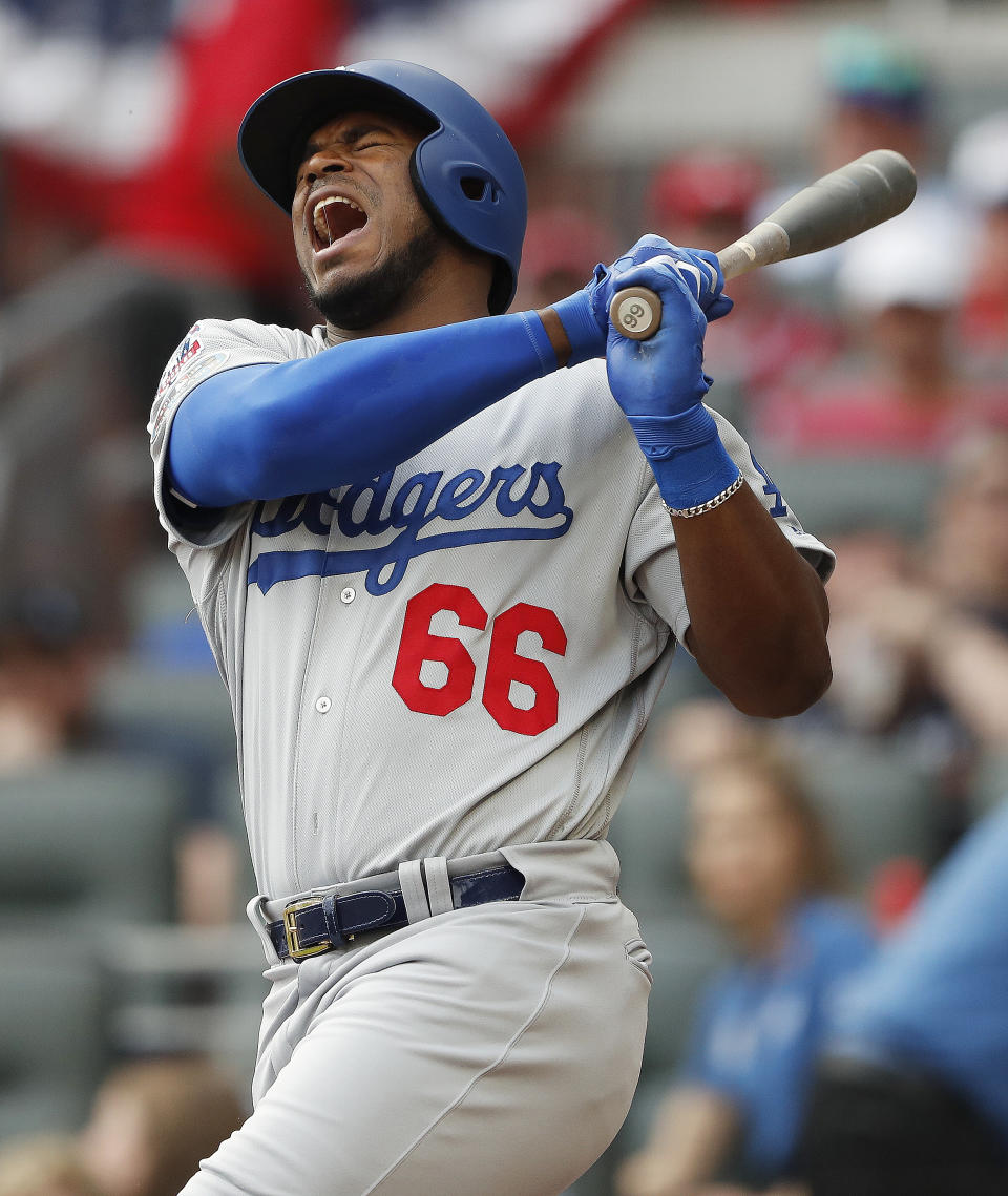 Los Angeles Dodgers' Yasiel Puig (66) reacts at the plate after hitting a foul tip against the Atlanta Braves during the second inning in Game 4 of baseball's National League Division Series, Monday, Oct. 8, 2018, in Atlanta. (AP Photo/John Bazemore)