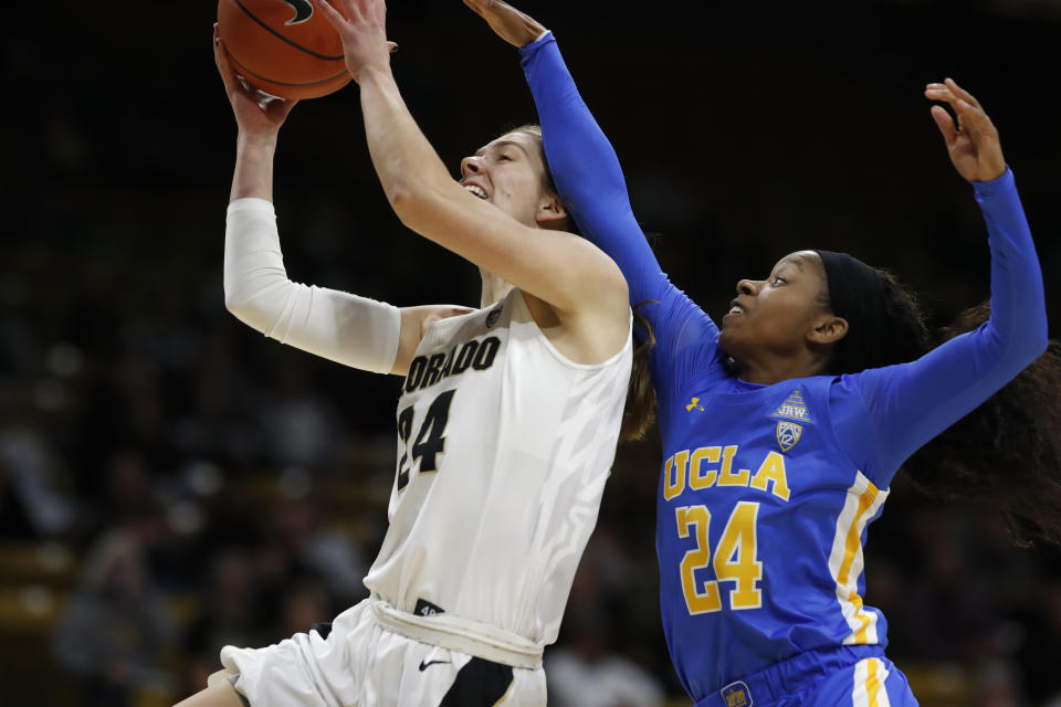 Colorado guard Aubrey Knight, left, is fouled as she goes up for a basket by UCLA guard Japreece Dean in the first half of an NCAA college basketball game Sunday, Jan. 12, 2020, in Boulder, Colo. (AP Photo/David Zalubowski)