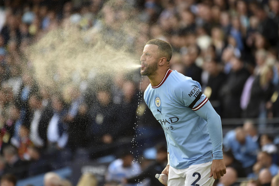 Manchester City's Kyle Walker spits water during the English Premier League soccer match between Manchester City and Manchester United at Etihad stadium in Manchester, England, Sunday, Oct. 2, 2022. (AP Photo/Rui Vieira)