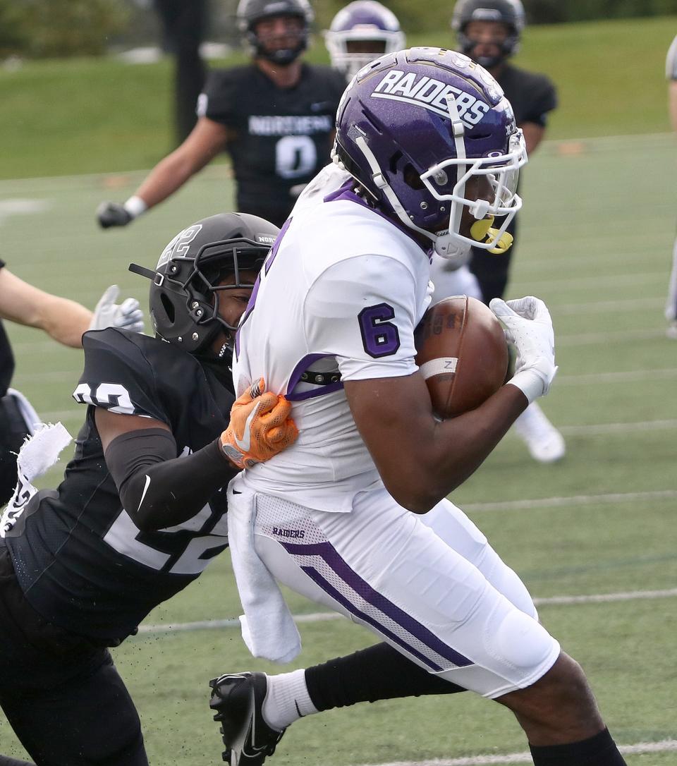 Mount Union's Wayne Ruby (6) scores a touchdown as ONU's Dwayne Rowe defends during first-half action at Ohio Northern University Saturday, October 1, 2022.