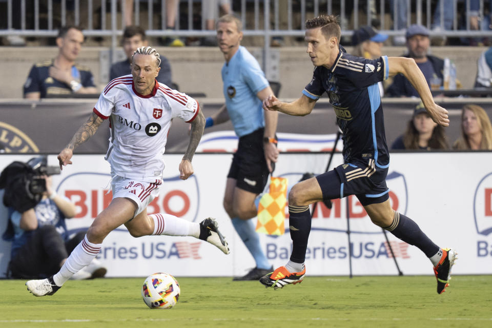 Toronto FC's Federico Bernardeschi, left, drives to the goal with the ball against Philadelphia Union's Jack Elliott, right, during the first half of an MLS soccer match, Wednesday, May 29, 2024, in Chester, Pa. (AP Photo/Chris Szagola)