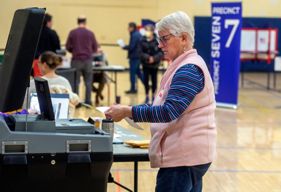 Terry Miller, warden for Precinct 10, enters mail-in ballots Tuesday for Natick's annual town election at the Community Senior Center, March 26, 2024.