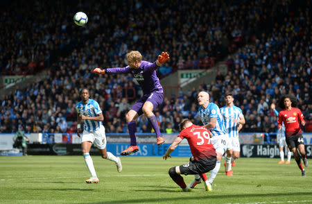 Soccer Football - Premier League - Huddersfield Town v Manchester United - John Smith's Stadium, Huddersfield, Britain - May 5, 2019 Huddersfield Town's Jonas Lossl in action with Manchester United's Scott McTominay REUTERS/Peter Powell