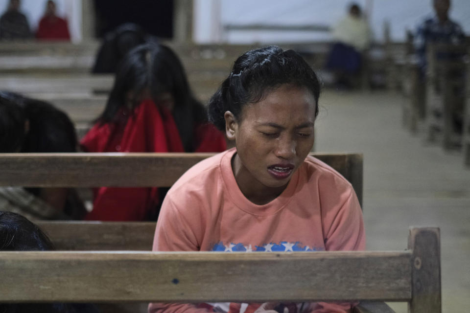 Tears flow down the cheek of a Konyak Naga girl as she prays inside a church in Oting village, in the northeastern Indian state of Nagaland, Wednesday, Dec. 15, 2021. High up in the hills along India's border with Myanmar, Oting village in the northeastern state of Nagaland is in mourning after more than a dozen people were killed by soldiers. The incident earlier this month is the latest violence to shake the state of Nagaland and has left Oting village reeling in shock and grief for their lost ones. (AP Photo/Yirmiyan Arthur)