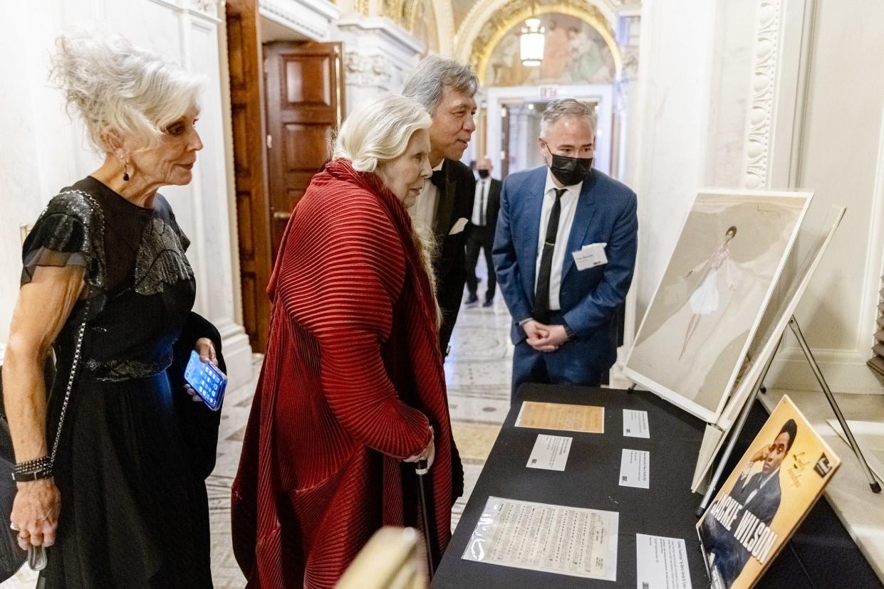 Joni Mitchell looks over a collections display at the Kennedy Center Honors Medallion Ceremony at the Library of Congress, December 4, 2021.