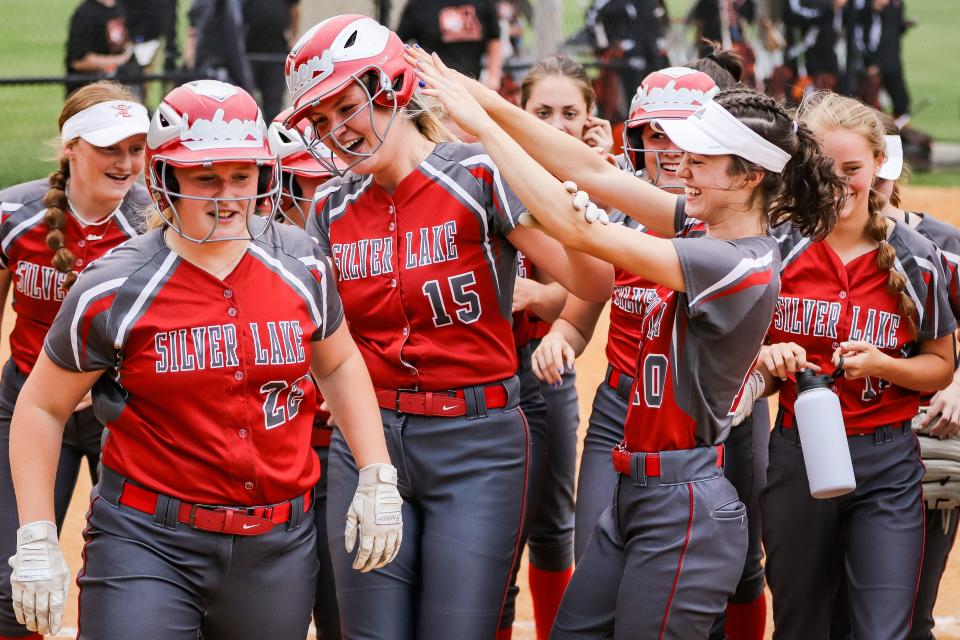 The Silver Lake softball team celebrates after Delaney Moquin (No. 15) hit a two-run home run during a game against Oliver Ames in the Div. 2 Round of 32 on Tuesday, June 6, 2023.