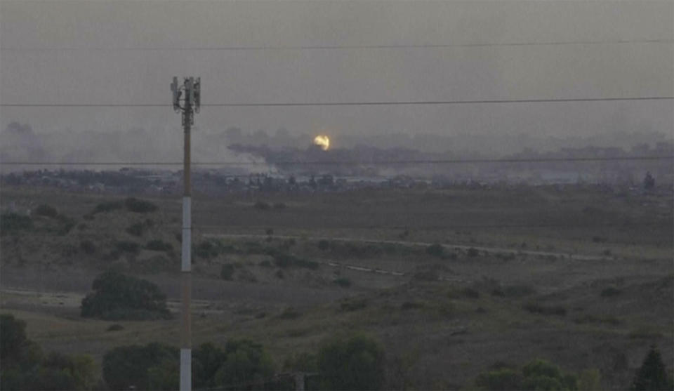 This frame grab taken from video shot in southern Israel shows flames and smoke rising from what Palestinian medics say is an Israeli airstrike in Gaza, Sunday, May 26, 2024. (AP Photo/Josphat Kasire)