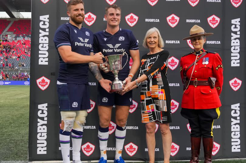 Co-captains Luke Crosbie and Stafford McDowall receive the Douglas JL Horn Memorial Cup