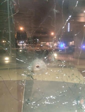 A bullet hole is seen in a window of the Dallas police headquarters in Dallas, Texas, in this handout photo released by the Dallas Police Department on June 13, 2015. REUTERS/Dallas Police Department/Handout via Reuters