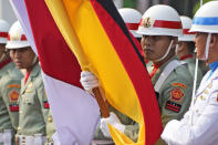 Honor guards hold German and Indonesian flags during the meeting between German Defense Minister Boris Pistorius and Indonesian Defense Minister Prabowo Subianto in Jakarta, Indonesia, Monday, June 5, 2023. (AP Photo/Dita Alangkara)