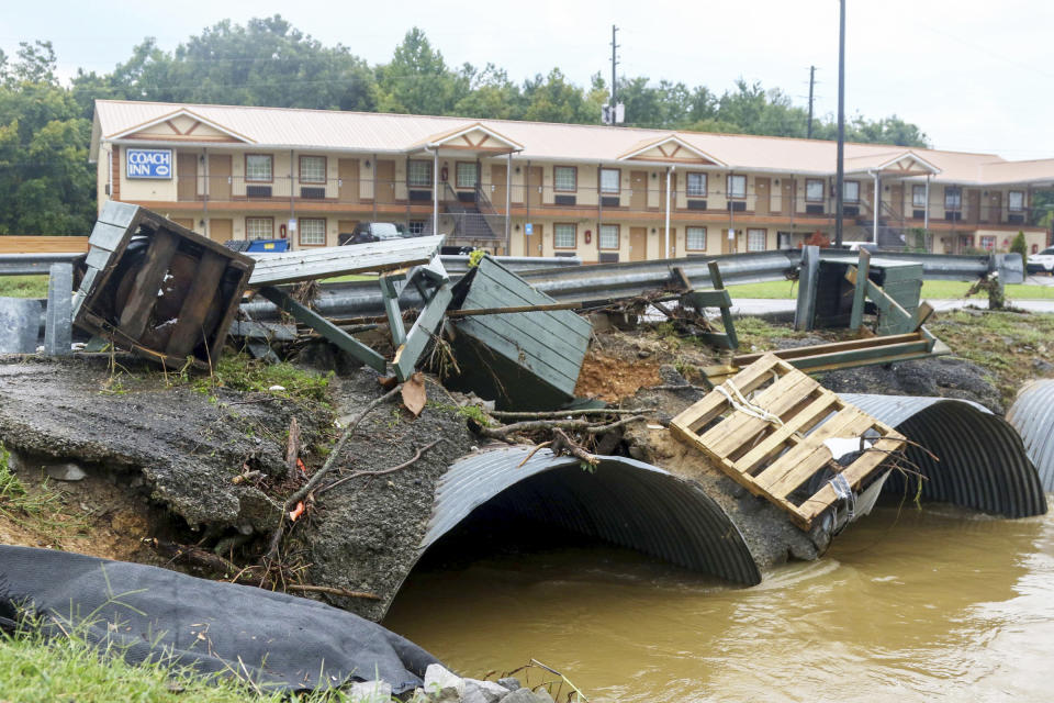 Trash cans from JR Dick Dowdy Park wash up outside of the Coach Inn Sunday, Sept. 4, 2022, in Summerville, Ga. After heavy rainfall, a Flash Flood Warning was issued in Summerville Sunday. (Olivia Ross/Chattanooga Times Free Press via AP)