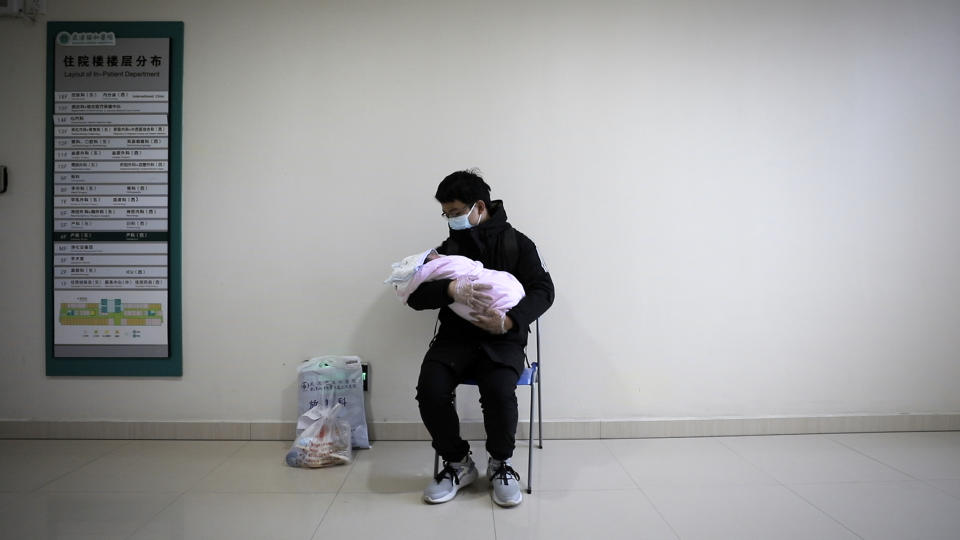 A man holds his newborn baby in hospital during the peak of the COVID-19 outbreak in Wuhan, China in a scene from the documentary "76 Days." The film, shot in four Wuhan hospitals, captures a local horror before it became a global nightmare. Given the constraints at the time on footage and information from Wuhan, it's a rare window into the infancy of the pandemic. (MTV Documentary Films via AP)