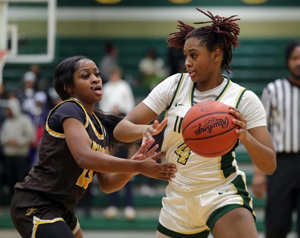 STVM guard Erica King, right, drives to the basket against Brush guard Brooklynn Vickers during the first half of a high school basketball game, Wednesday, Jan. 31, 2024, in Akron, Ohio.